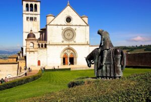 Statue of St Francis riding toward his cathedral